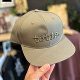 A cap with a straight brim TĒTIS.
