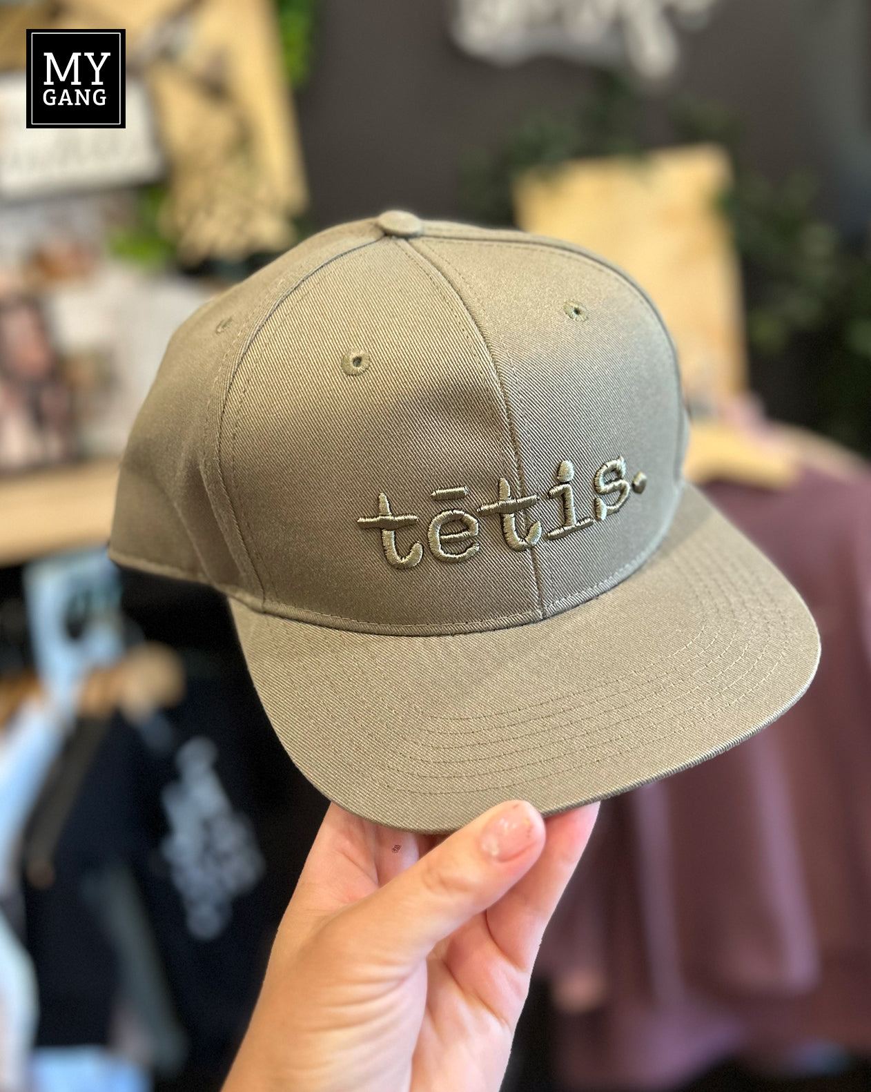 A cap with a straight brim TĒTIS.